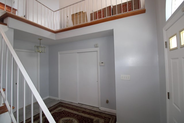 242 W Centennial Ave, Roosevelt, NY 11575 - entryway featuring a high ceiling, stairs, and a chandelier