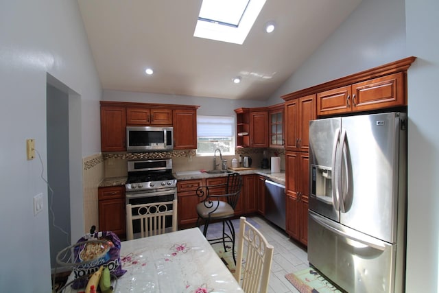 242 W Centennial Ave, Roosevelt, NY 11575 - kitchen with stainless steel appliances, lofted ceiling, a skylight, backsplash, and recessed lighting