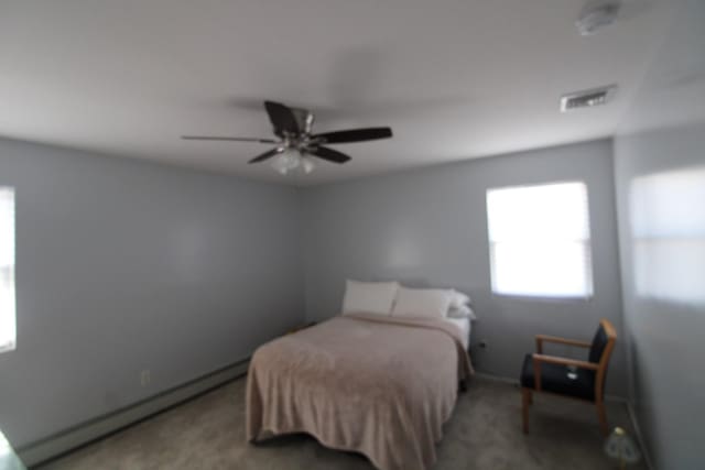 242 W Centennial Ave, Roosevelt, NY 11575 - bedroom featuring a baseboard heating unit, carpet floors, and a ceiling fan