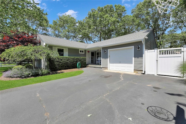75 Lynncliff Rd, Hampton Bays, NY 11946 - ranch-style house featuring an attached garage, a gate, driveway, and a shingled roof