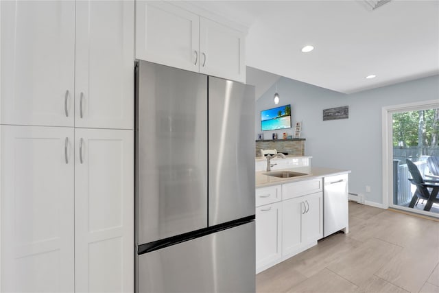 75 Lynncliff Rd, Hampton Bays, NY 11946 - kitchen featuring freestanding refrigerator, dishwasher, white cabinets, light countertops, and recessed lighting