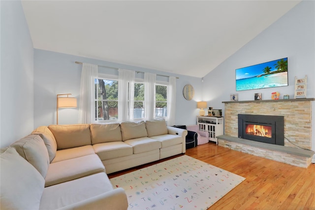 75 Lynncliff Rd, Hampton Bays, NY 11946 - living room featuring wood finished floors, a stone fireplace, and high vaulted ceiling