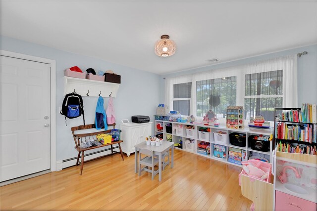 75 Lynncliff Rd, Hampton Bays, NY 11946 - playroom with a baseboard radiator and wood finished floors