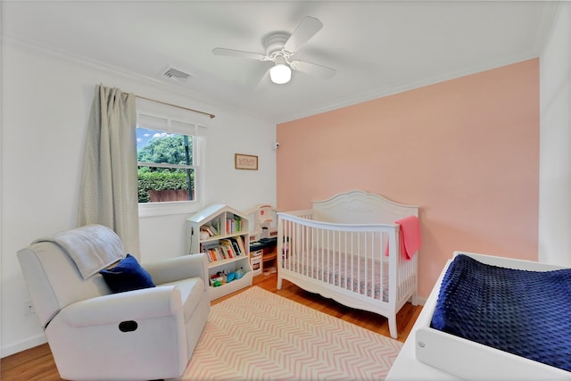 75 Lynncliff Rd, Hampton Bays, NY 11946 - bedroom with wood finished floors, crown molding, ceiling fan, and a crib