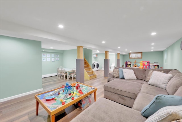 75 Lynncliff Rd, Hampton Bays, NY 11946 - living area with washing machine and dryer, light wood finished floors, recessed lighting, and stairway