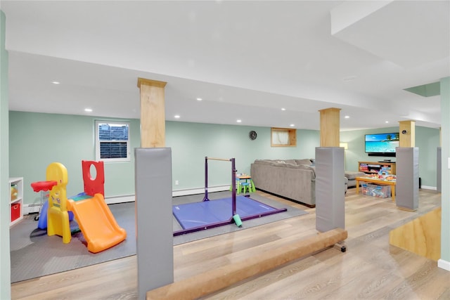 75 Lynncliff Rd, Hampton Bays, NY 11946 - workout area with wood finished floors, baseboard heating, and recessed lighting