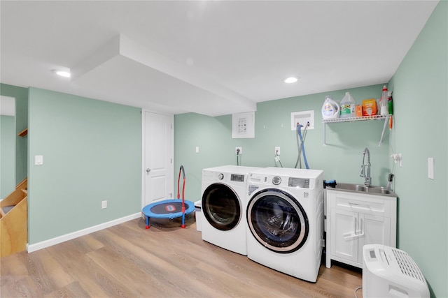 75 Lynncliff Rd, Hampton Bays, NY 11946 - laundry room featuring light wood finished floors, washing machine and clothes dryer, recessed lighting, and cabinet space