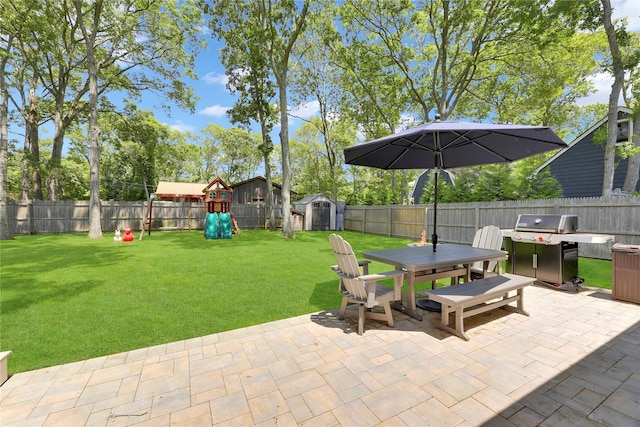 75 Lynncliff Rd, Hampton Bays, NY 11946 - fenced backyard with outdoor dining area, a shed, a patio area, a playground, and grilling area