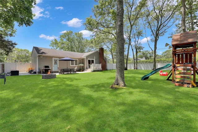 75 Lynncliff Rd, Hampton Bays, NY 11946 - fenced backyard featuring an outdoor fire pit, a playground, and a patio