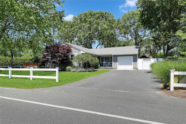 75 Lynncliff Rd, Hampton Bays, NY 11946 - view of front of house with an attached garage, asphalt driveway, and a gate