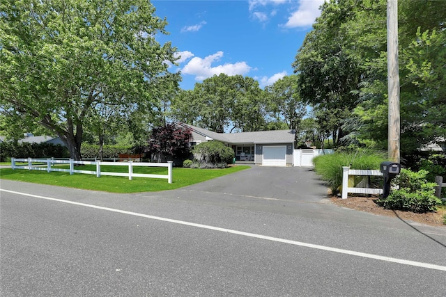 75 Lynncliff Rd, Hampton Bays, NY 11946 - view of front of property with a garage and asphalt driveway