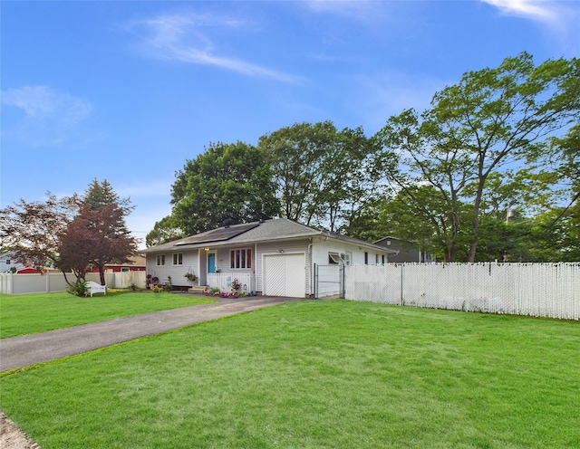 237 Donald Blvd, Holbrook, NY 11741 - view of front of house with driveway, a garage, and roof mounted solar panels