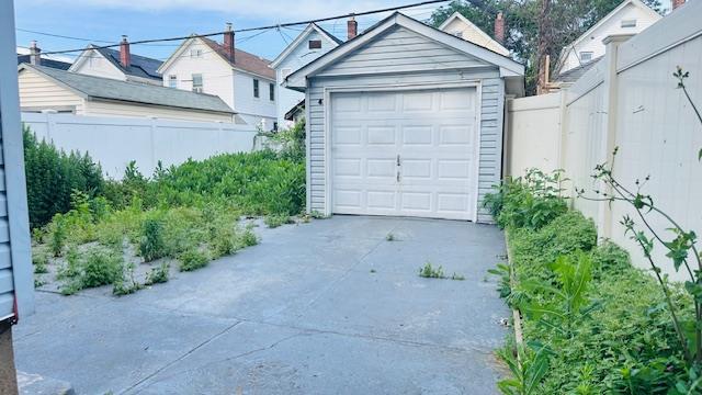 9331 207th St, Queens Village, NY 11428 - detached garage featuring concrete driveway