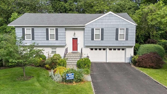 12 Edgemont Cir, Scarsdale, NY 10583 - split foyer home featuring a garage, asphalt driveway, a front yard, and brick siding