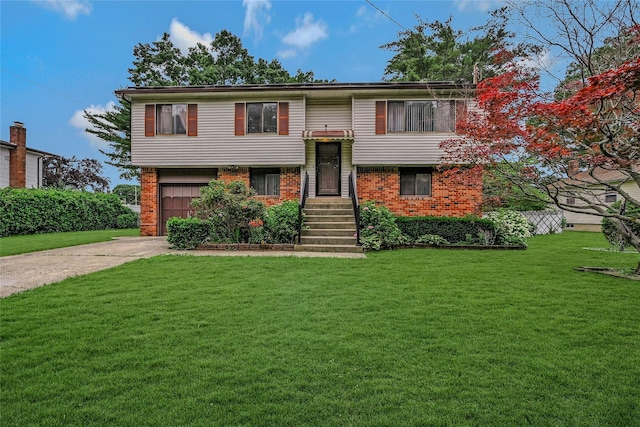 103 Lakeway Dr, West Babylon, NY 11704 - split foyer home with concrete driveway, brick siding, a front yard, and a garage