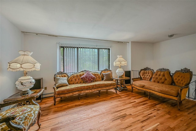 103 Lakeway Dr, West Babylon, NY 11704 - living area with light wood-style floors and a baseboard heating unit