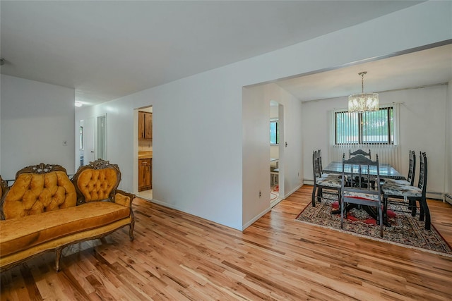 103 Lakeway Dr, West Babylon, NY 11704 - dining space with a chandelier and light wood-type flooring