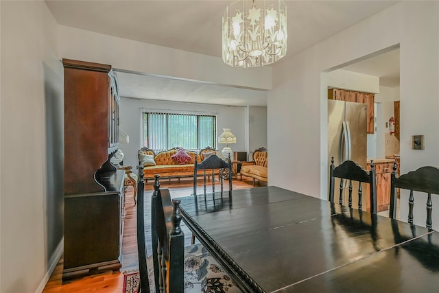 103 Lakeway Dr, West Babylon, NY 11704 - dining room featuring a chandelier and light wood-style flooring