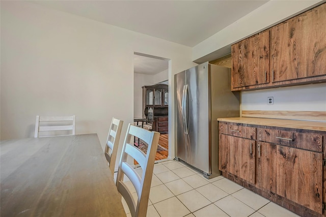 103 Lakeway Dr, West Babylon, NY 11704 - kitchen featuring freestanding refrigerator, brown cabinetry, and light tile patterned flooring