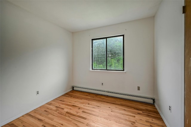 103 Lakeway Dr, West Babylon, NY 11704 - spare room featuring a baseboard radiator and light wood finished floors