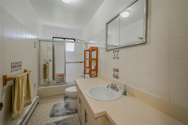 103 Lakeway Dr, West Babylon, NY 11704 - bathroom with tile walls, a baseboard radiator, enclosed tub / shower combo, vanity, and tile patterned floors