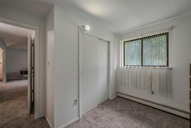 103 Lakeway Dr, West Babylon, NY 11704 - unfurnished bedroom with a baseboard radiator, carpet, and a closet