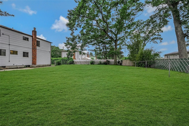 103 Lakeway Dr, West Babylon, NY 11704 - fenced backyard with a storage unit