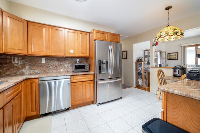 179 Alice Ave, Oceanside, NY 11572 - kitchen with appliances with stainless steel finishes, tasteful backsplash, hanging light fixtures, light tile patterned flooring, and light stone counters