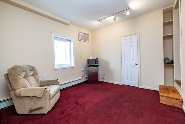 179 Alice Ave, Oceanside, NY 11572 - sitting room with a baseboard radiator, a wall unit AC, track lighting, and dark colored carpet
