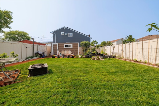 179 Alice Ave, Oceanside, NY 11572 - back of property with an outdoor fire pit and a fenced backyard