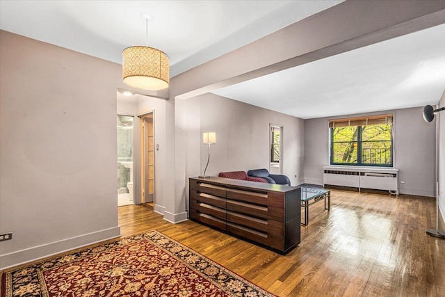 139-15 83rd Ave Unit 520, Briarwood, NY 11435 - bedroom featuring radiator, wood finished floors, and ensuite bath