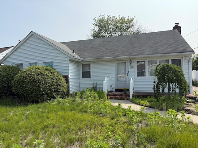 761 Barkley Ave, East Meadow, NY 11554 - view of front of house featuring a chimney and roof with shingles
