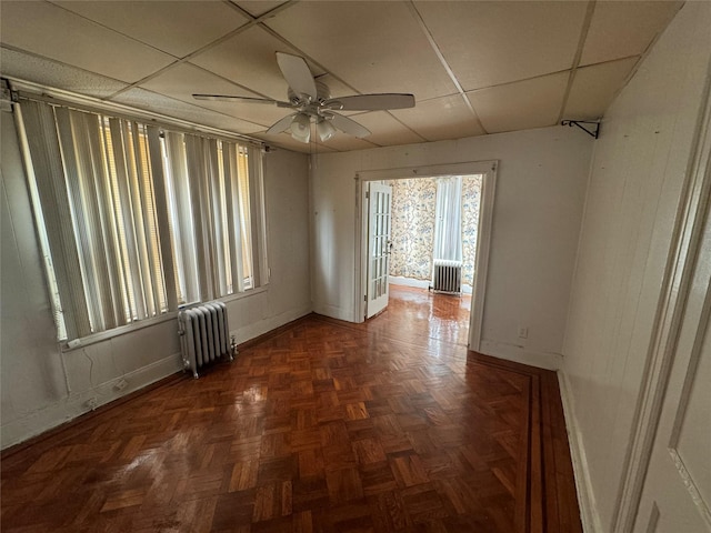 107-03 32nd Ave, East Elmhurst, NY 11369 - spare room featuring radiator heating unit, a paneled ceiling, and a ceiling fan