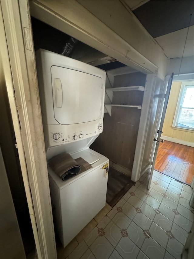 107-03 32nd Ave, East Elmhurst, NY 11369 - laundry room featuring stacked washer and clothes dryer and baseboards