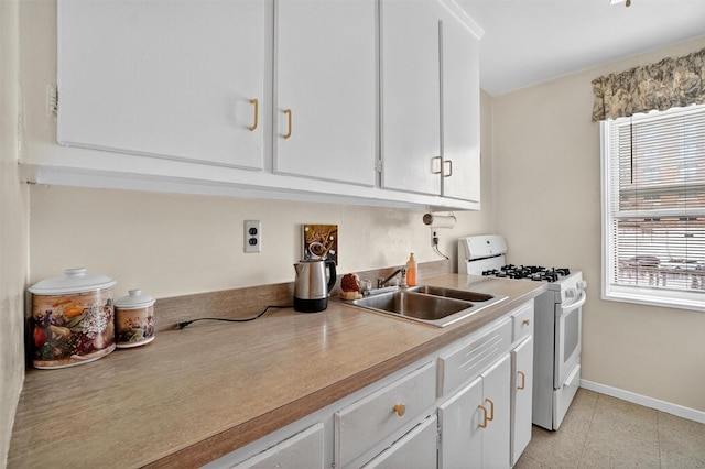 355 Bronx River Rd Unit 4B, Yonkers, NY 10704 - kitchen featuring white gas stove, plenty of natural light, and white cabinetry