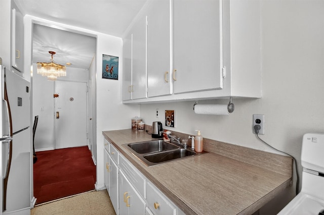 355 Bronx River Rd Unit 4B, Yonkers, NY 10704 - kitchen featuring freestanding refrigerator, white cabinetry, and a chandelier