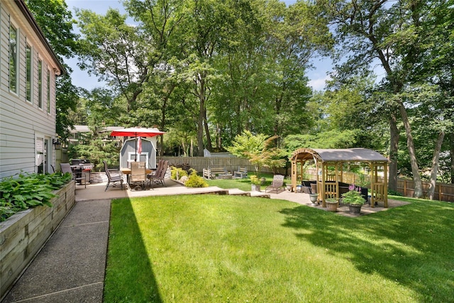 22 Woodchuck Ln, East Setauket, NY 11733 - fenced backyard featuring a gazebo, a patio area, and view of scattered trees