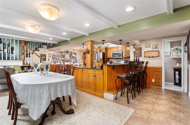 22 Woodchuck Ln, East Setauket, NY 11733 - dining room with beam ceiling, stairway, a wainscoted wall, recessed lighting, and light tile patterned flooring