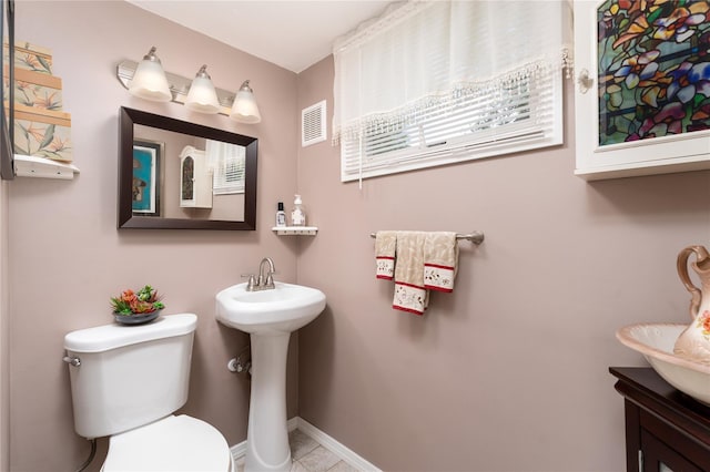22 Woodchuck Ln, East Setauket, NY 11733 - half bathroom with toilet and tile patterned floors
