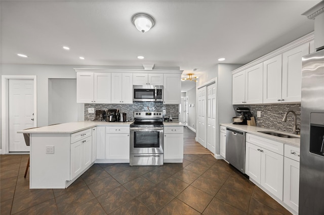 16 Melvin Ave, Farmingville, NY 11738 - kitchen with stainless steel appliances, a peninsula, decorative backsplash, light countertops, and white cabinets