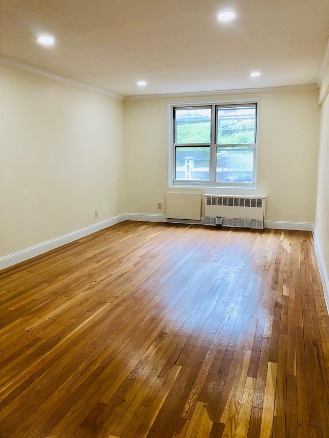 1296 Midland Ave Unit A3, Yonkers, NY 10704 - unfurnished room featuring radiator heating unit, wood-type flooring, and crown molding