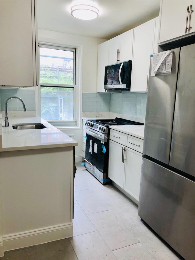 1296 Midland Ave Unit A3, Yonkers, NY 10704 - kitchen with stainless steel appliances, light countertops, tasteful backsplash, and white cabinets