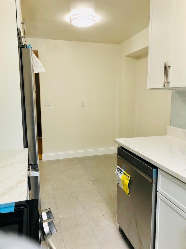 1296 Midland Ave Unit A3, Yonkers, NY 10704 - kitchen with stainless steel dishwasher, white cabinetry, light stone countertops, and light flooring