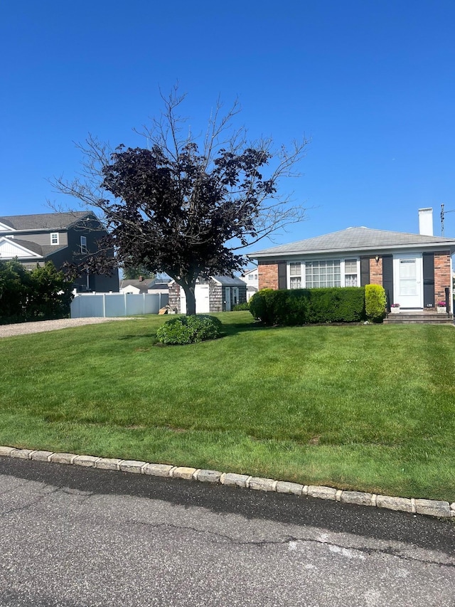 138 Sequams Ln E, West Islip, NY 11795 - view of front of house featuring a chimney and brick siding