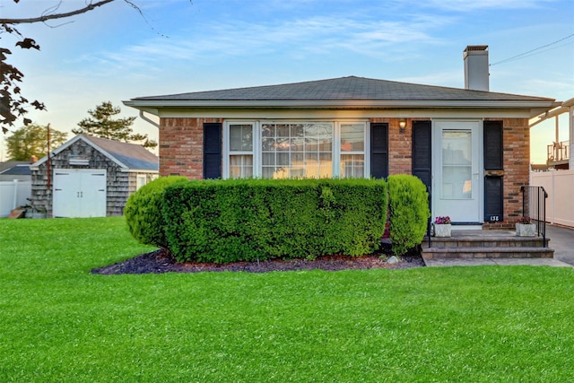 138 Sequams Ln E, West Islip, NY 11795 - view of front of property with brick siding, a shed, and a chimney