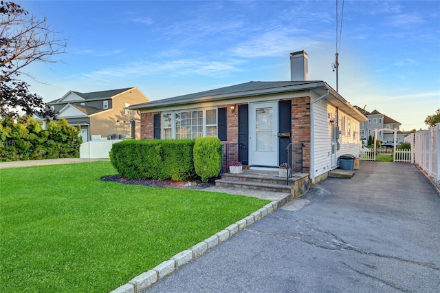 138 Sequams Ln E, West Islip, NY 11795 - view of front of home with a chimney and brick siding