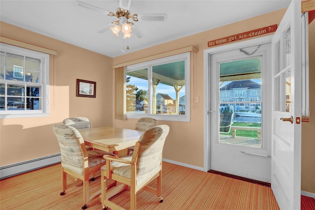 138 Sequams Ln E, West Islip, NY 11795 - dining area with a baseboard heating unit, a ceiling fan, and light colored carpet