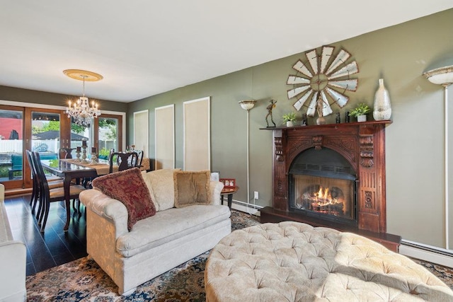 17 Sterling Dr, Lake Grove, NY 11755 - living room featuring a chandelier, wood finished floors, baseboard heating, and a lit fireplace