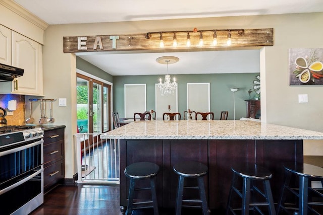 17 Sterling Dr, Lake Grove, NY 11755 - kitchen featuring double oven range, a breakfast bar, light stone countertops, a chandelier, and pendant lighting
