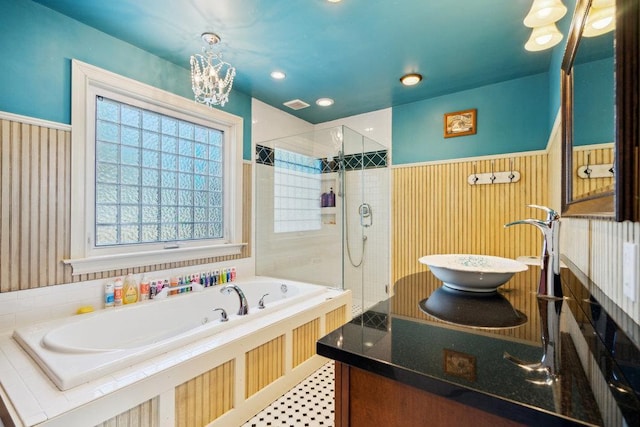 17 Sterling Dr, Lake Grove, NY 11755 - bathroom featuring a bath, a stall shower, healthy amount of natural light, a chandelier, and a wainscoted wall